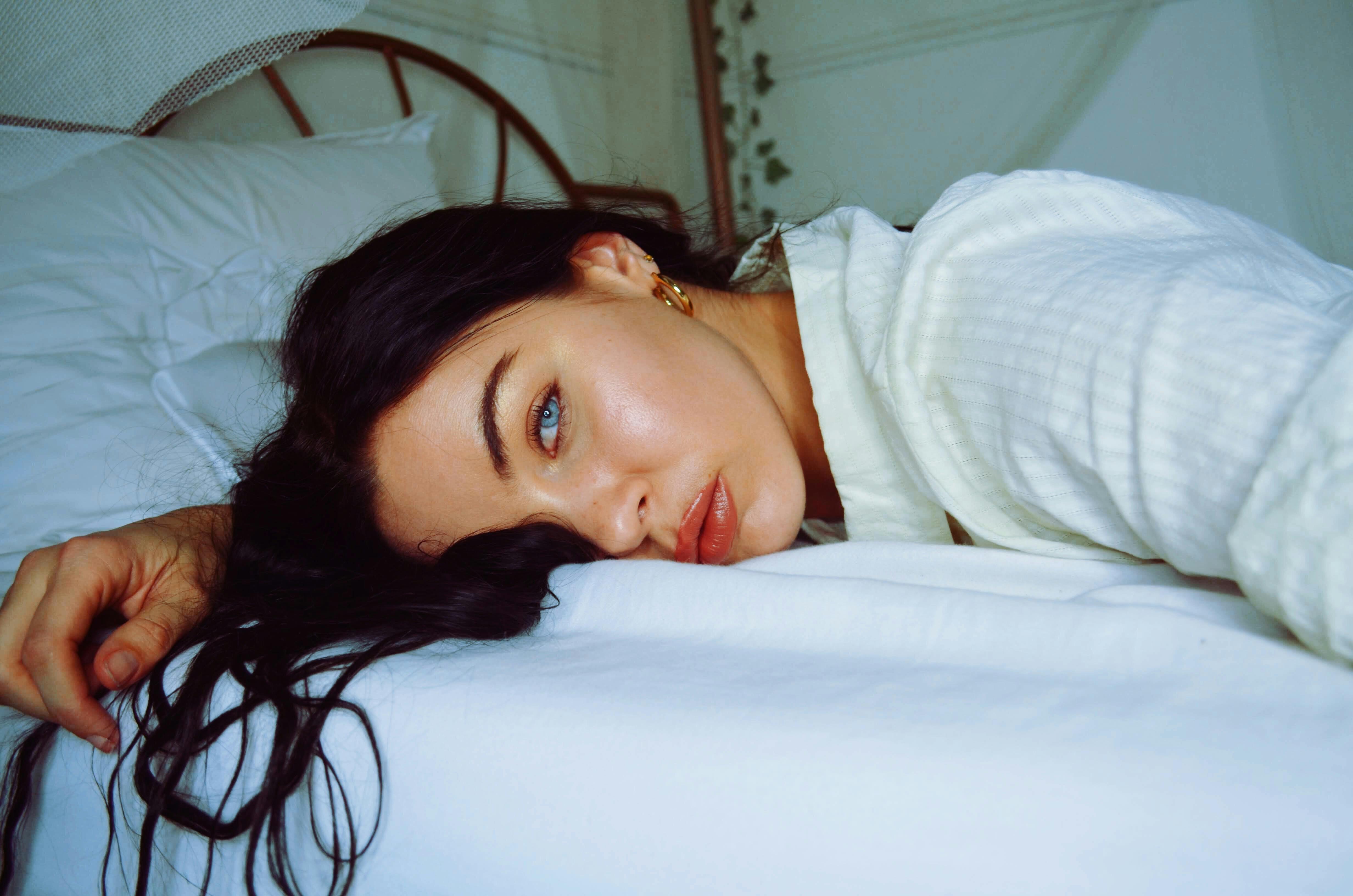 Tired woman resting on bed | Source: Pexels