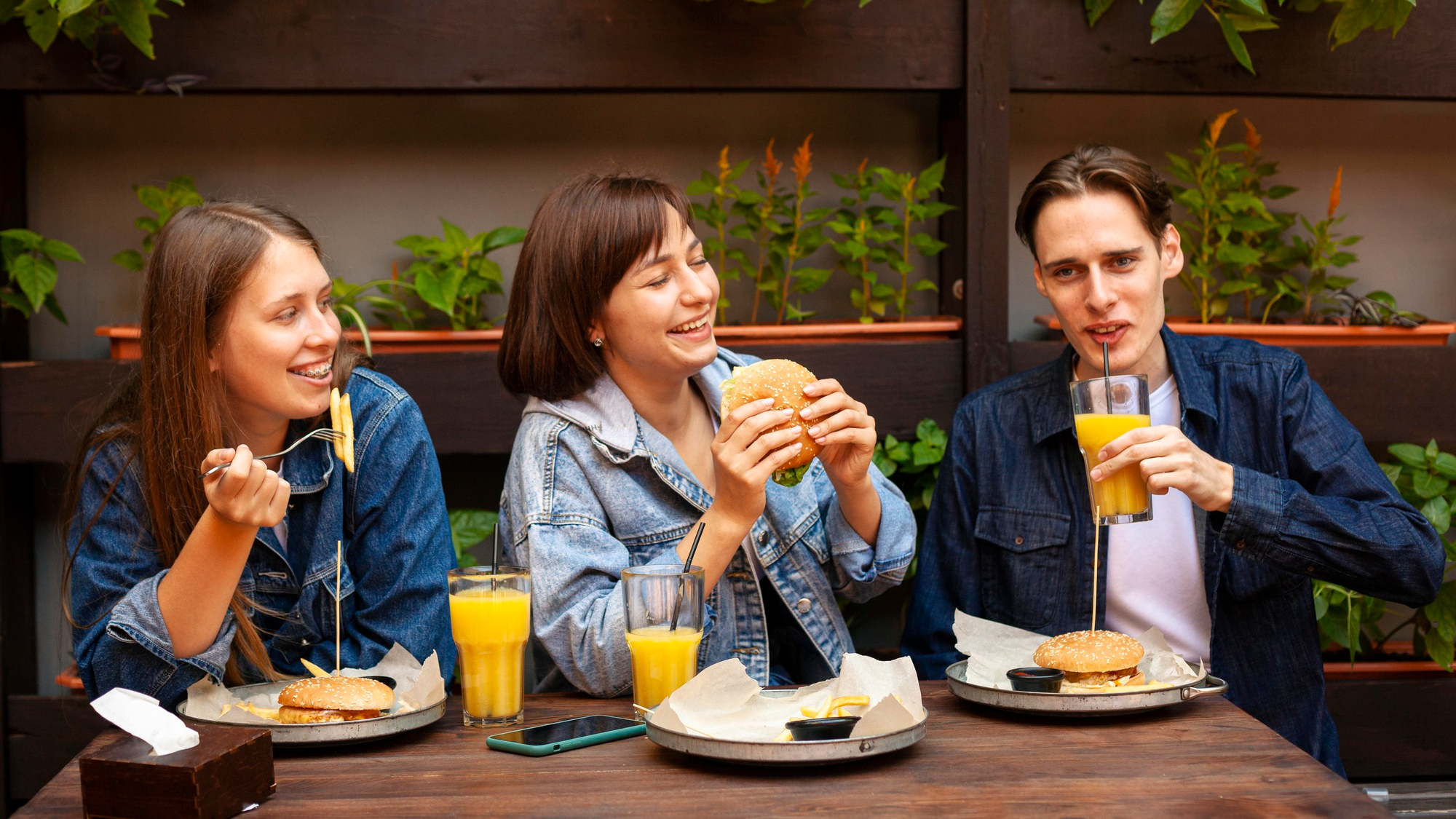 A group of people having lunch | Source: Freepik