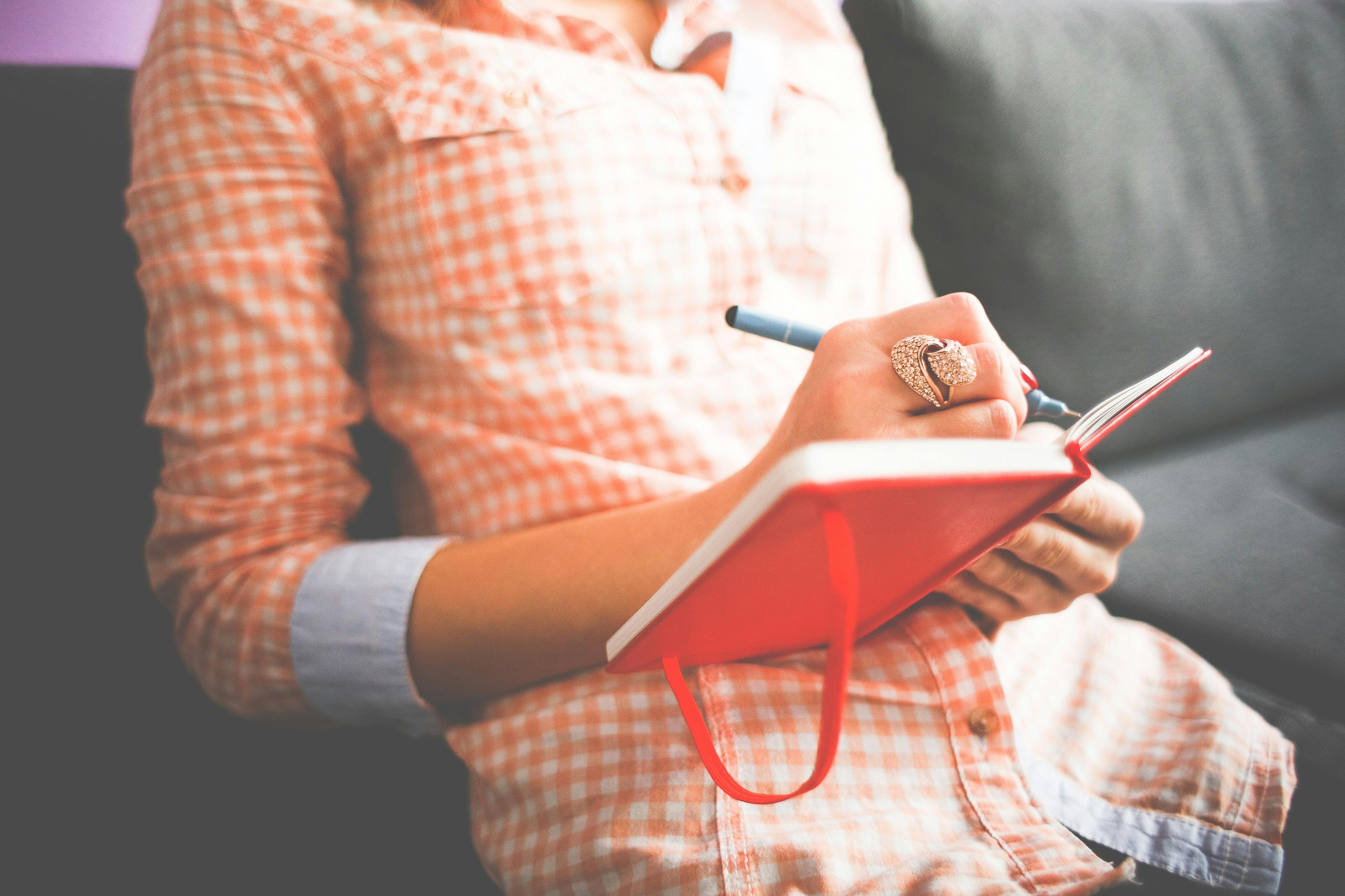Woman journaling | Source: Pexels